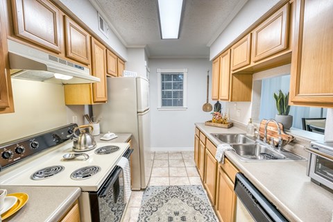 a kitchen with a stove top oven and a sink